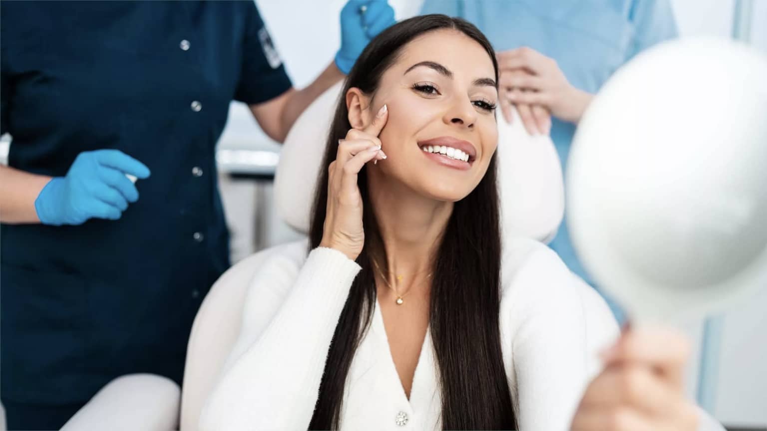 A woman choosing a dermal filler with the help of two nurses