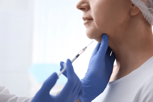 doctor injecting botox into the patients chin while practising safe injecting
